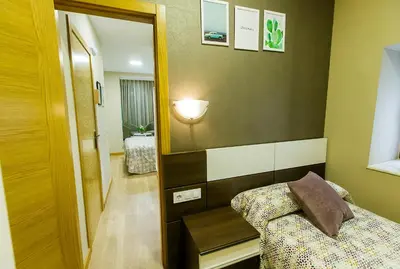 Cama o camas de una habitación en Hospedería Castilla Plaza Mayor
