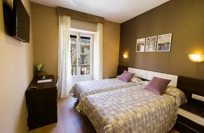 Cama o camas de una habitación en Hospedería Castilla Plaza Mayor