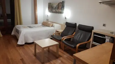 Cama o camas de una habitación en Apartamentos y Estudios LA RISTRA