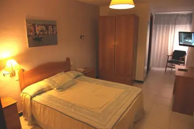 Cama o camas de una habitación en Hotel El Emigrante