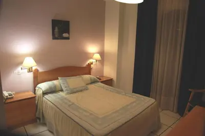 Cama o camas de una habitación en Hotel El Emigrante