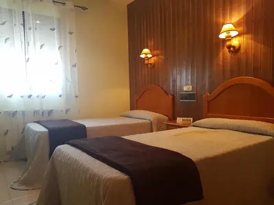 Cama o camas de una habitación en Hotel Carvajal