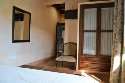 Cama o camas de una habitación en Apartamentos Turísticos - Hostal Los Alisos