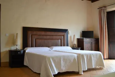Cama o camas de una habitación en Apartamentos Turísticos - Hostal Los Alisos