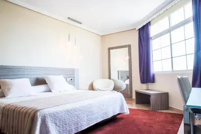 Cama o camas de una habitación en Hospedium Hotel Triana