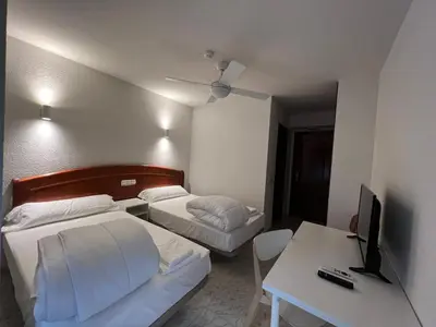 Cama o camas de una habitación en Hostal la Embajada