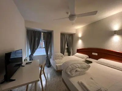 Cama o camas de una habitación en Hostal la Embajada