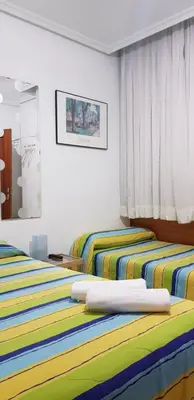 Cama o camas de una habitación en Pension Salamanca