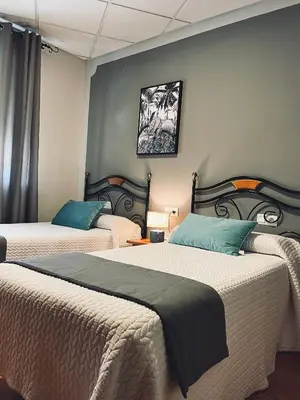 Cama o camas de una habitación en Hostal Paulino