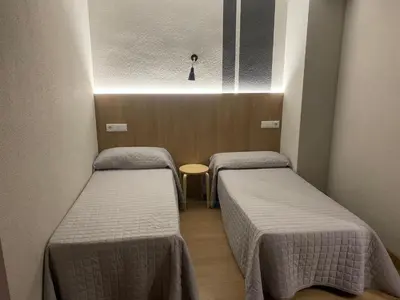 Cama o camas de una habitación en Hostal Uría