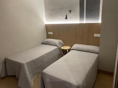Cama o camas de una habitación en Hostal Uría