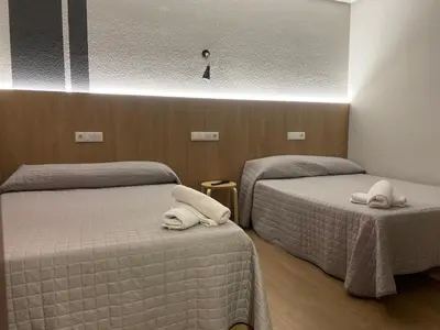Cama o camas de una habitación en Hostal Uría