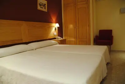 Cama o camas de una habitación en Hotel Alegría