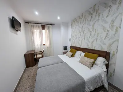 Cama o camas de una habitación en Apartamentos Arcos