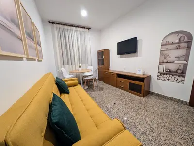 Una televisión o centro de entretenimiento en Apartamentos Arcos