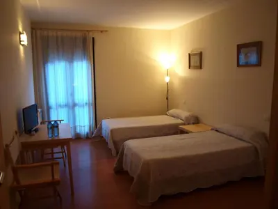 Cama o camas de una habitación en Apartamentos Turísticos La Peña