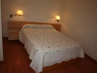 Cama o camas de una habitación en Apartamentos Turísticos La Peña
