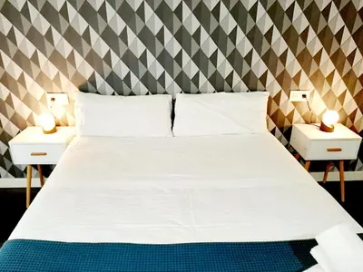 Cama o camas de una habitación en Apartamentos Arriba by gaiarooms