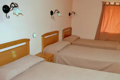 Cama o camas de una habitación en Albergue Aurora Boreal