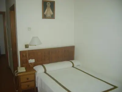 Cama o camas de una habitación en Hotel Hispanidad