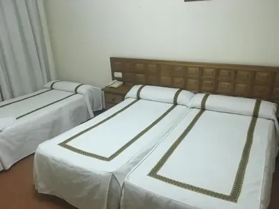 Cama o camas de una habitación en Hotel Hispanidad
