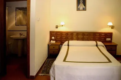 Cama o camas de una habitación en Hotel Hispanidad