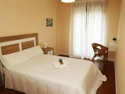 Cama o camas de una habitación en Apartamentos turisticos Puente Romano Portal 4 Bajo -A