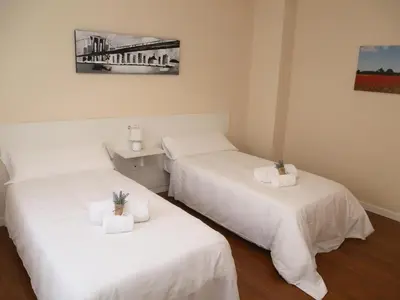 Cama o camas de una habitación en Apartamentos turisticos Puente Romano Portal 4 Bajo -A