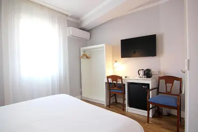 Cama o camas de una habitación en Hostal Los Castañuelos