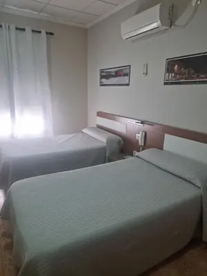 Cama o camas de una habitación en Hostal Restaurante el Paraíso