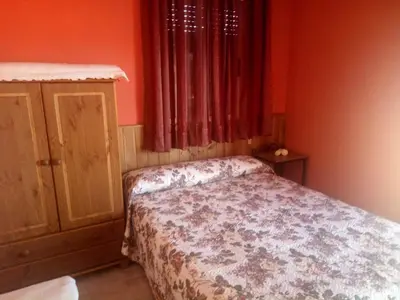 Cama o camas de una habitación en Apartamentos La Presa