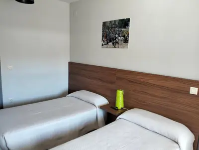 Cama o camas de una habitación en Hostal La Estación