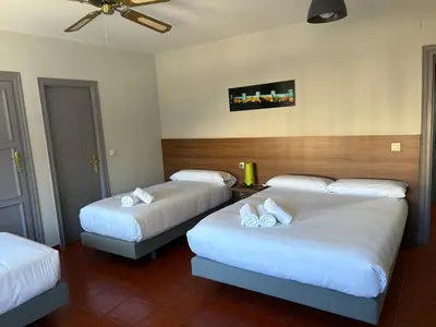 Cama o camas de una habitación en Hostal La Estación