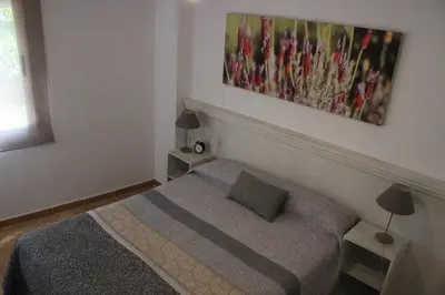 Cama o camas de una habitación en Apartamentos el Cardenillo