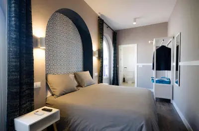 Cama o camas de una habitación en Apartamentos Suites Roma