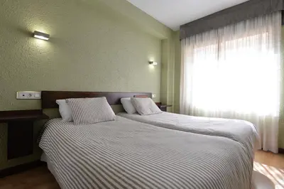Cama o camas de una habitación en Hostal Concejo