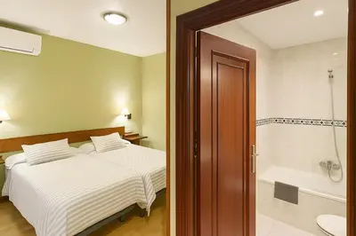 Cama o camas de una habitación en Hostal Concejo