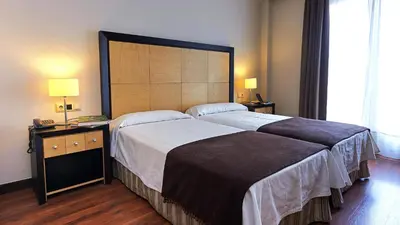 Cama o camas de una habitación en Hotel Las Cabañas