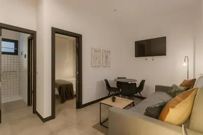 Una televisión o centro de entretenimiento en TRIA NOMINA Apartamentos Turísticos
