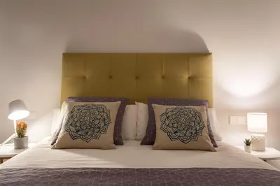 Cama o camas de una habitación en TRIA NOMINA Apartamentos Turísticos