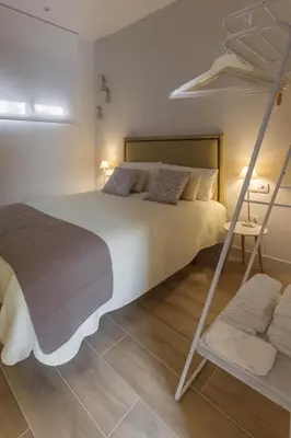Cama o camas de una habitación en TRIA NOMINA Apartamentos Turísticos