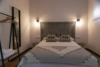 Cama o camas de una habitación en TRIA NOMINA Apartamentos Turísticos