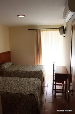 Cama o camas de una habitación en Nuevo Hostal Paulino