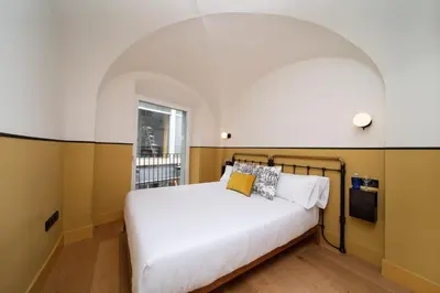 Cama o camas de una habitación en Apartamentos Habitavit en Cáceres