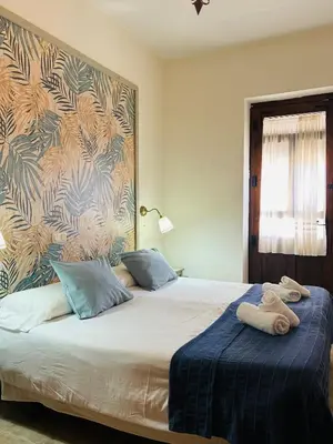 Cama o camas de una habitación en Hostal La Colonial