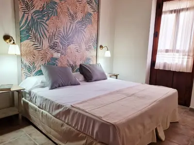 Cama o camas de una habitación en Hostal La Colonial