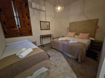 Cama o camas de una habitación en Hostal La Colonial