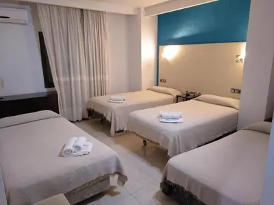 Cama o camas de una habitación en Hotel Nuevo Ara