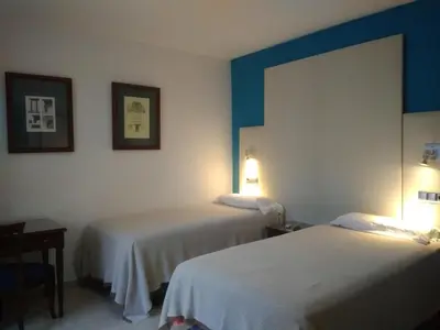 Cama o camas de una habitación en Hotel Nuevo Ara