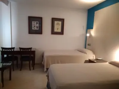 Cama o camas de una habitación en Hotel Nuevo Ara